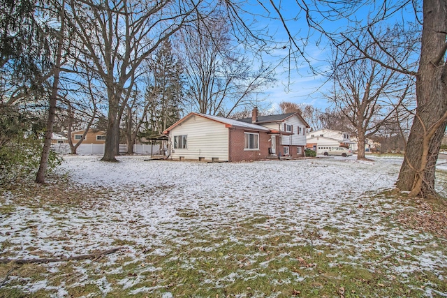 view of snowy exterior with a garage