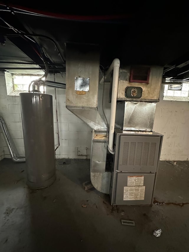 utility room featuring heating unit and gas water heater