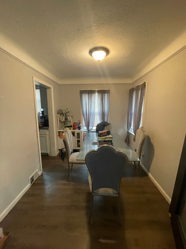 19307 Mansfield St, Detroit, MI 48235 - dining space with baseboards, dark wood-style flooring, a textured ceiling, and visible vents