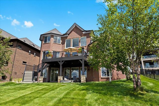 back of house with a lawn and a deck