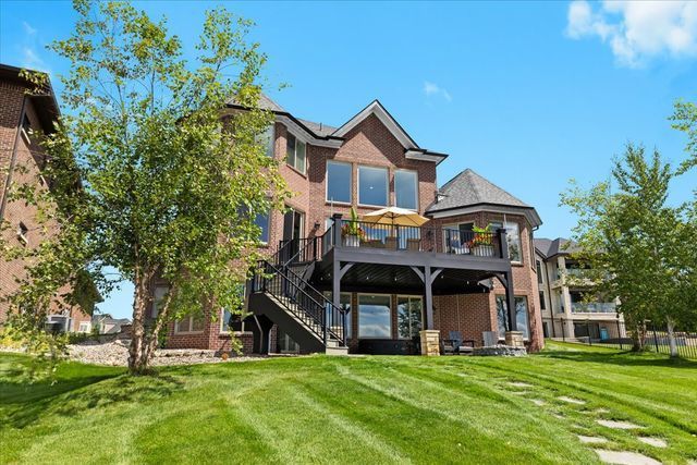 back of property featuring a yard and a deck