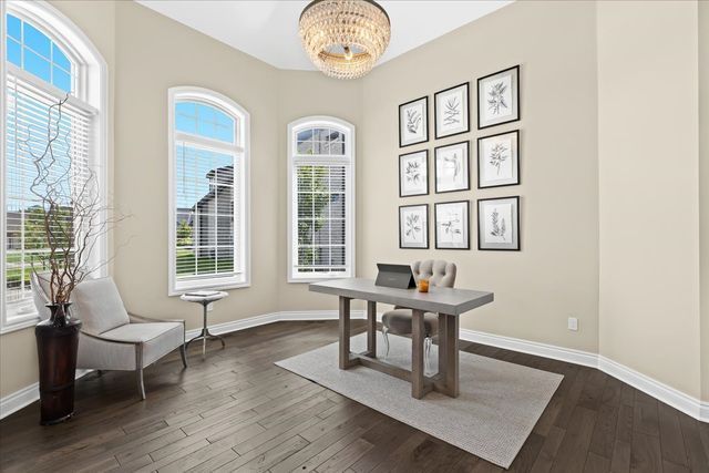 home office with dark hardwood / wood-style floors