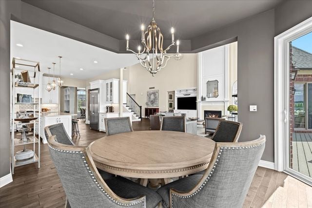 dining space with an inviting chandelier and dark hardwood / wood-style flooring