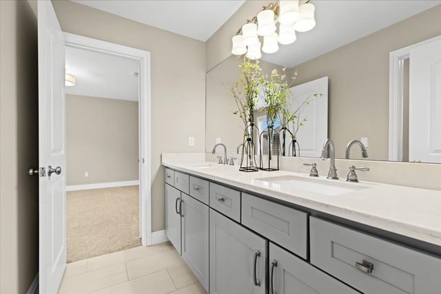 bathroom featuring vanity, tile patterned floors, and a chandelier