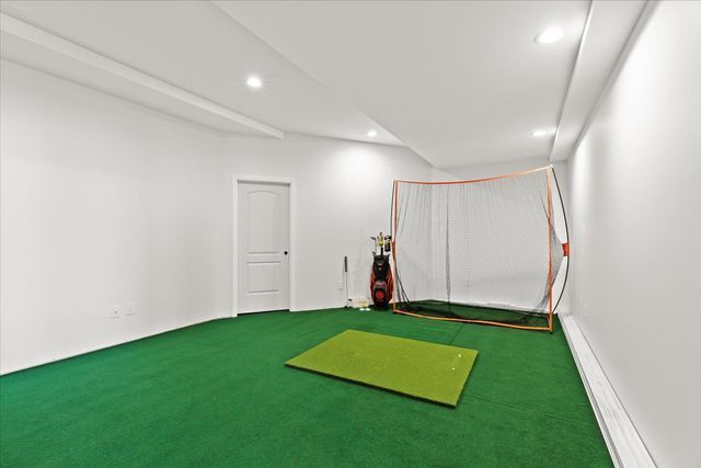 workout area with golf simulator and carpet flooring