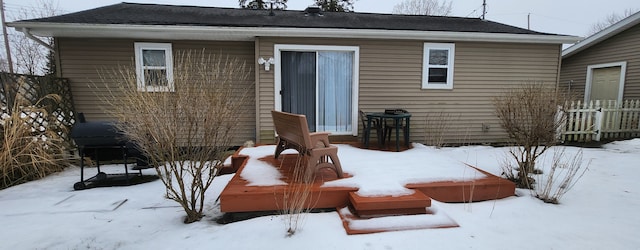 view of snow covered back of property