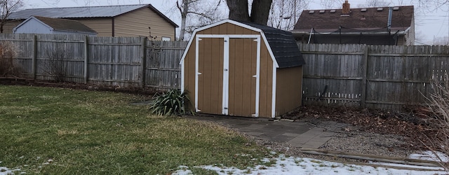 snow covered structure featuring a lawn