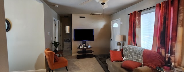 carpeted living room featuring ceiling fan