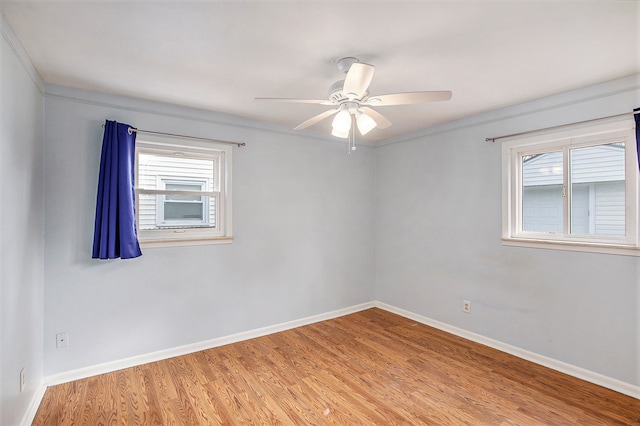 unfurnished room featuring wood-type flooring, plenty of natural light, and ceiling fan