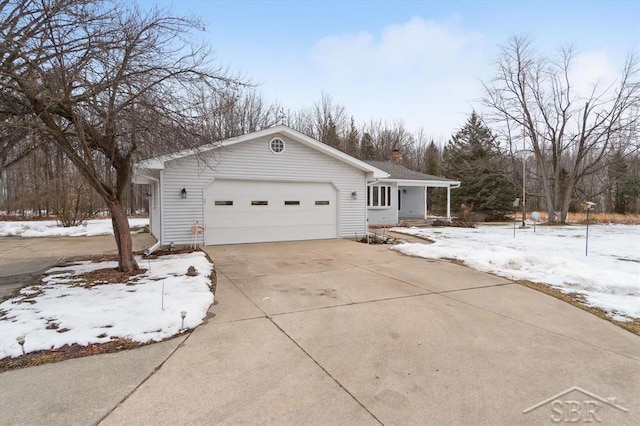 view of snow covered exterior with a garage