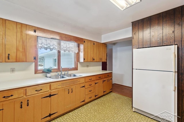 kitchen featuring white refrigerator and sink