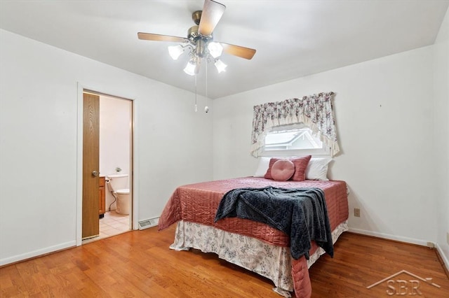 bedroom featuring ceiling fan, hardwood / wood-style floors, and ensuite bath