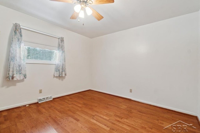 empty room with hardwood / wood-style flooring and ceiling fan