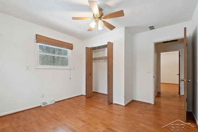 unfurnished bedroom featuring a closet, ceiling fan, and light hardwood / wood-style flooring