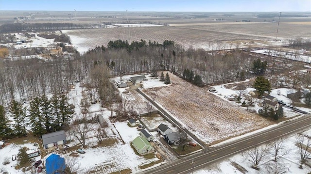 snowy aerial view featuring a rural view