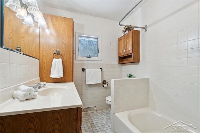 full bathroom with shower / bathing tub combination, tile walls, tile patterned flooring, vanity, and toilet