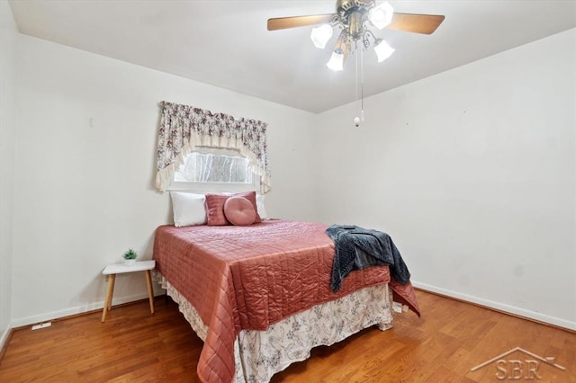 bedroom with hardwood / wood-style flooring and ceiling fan