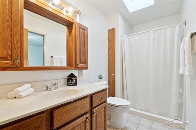 bathroom featuring a skylight, vanity, a shower with curtain, tile patterned floors, and toilet