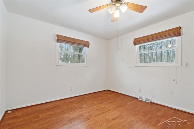 empty room featuring hardwood / wood-style floors and ceiling fan