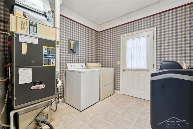 laundry room with heating unit, washer and clothes dryer, and light tile patterned floors