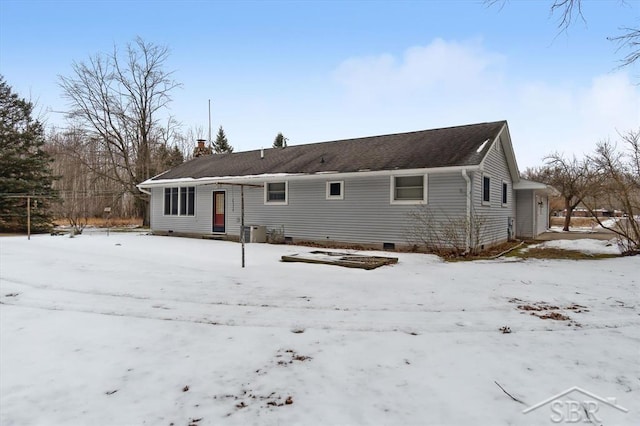 view of snow covered back of property