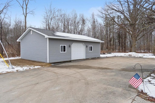 snow covered structure with a garage