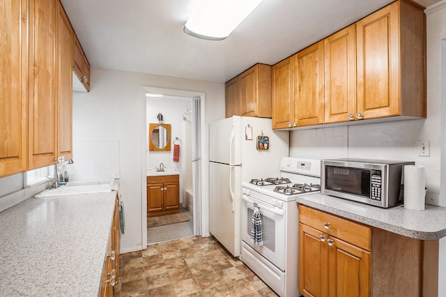 kitchen with white gas range and sink