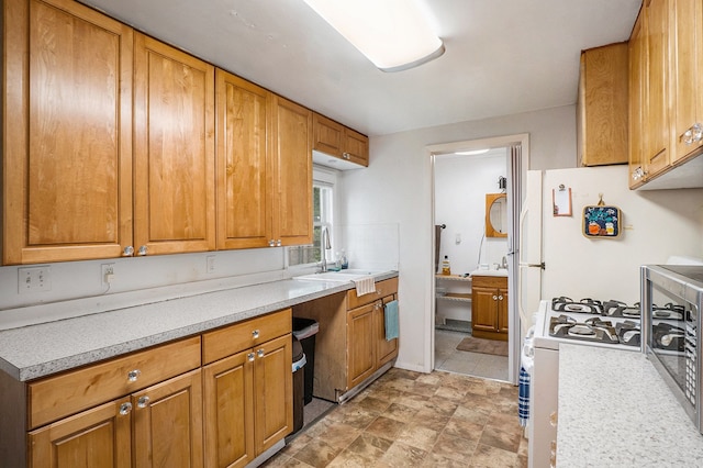 kitchen featuring sink and white gas stove