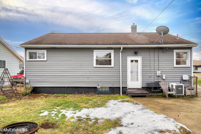 rear view of house featuring central AC unit