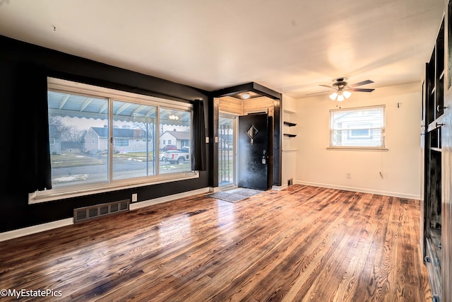 unfurnished living room featuring hardwood / wood-style floors and ceiling fan