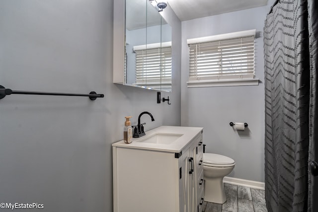 bathroom with vanity, toilet, and walk in shower