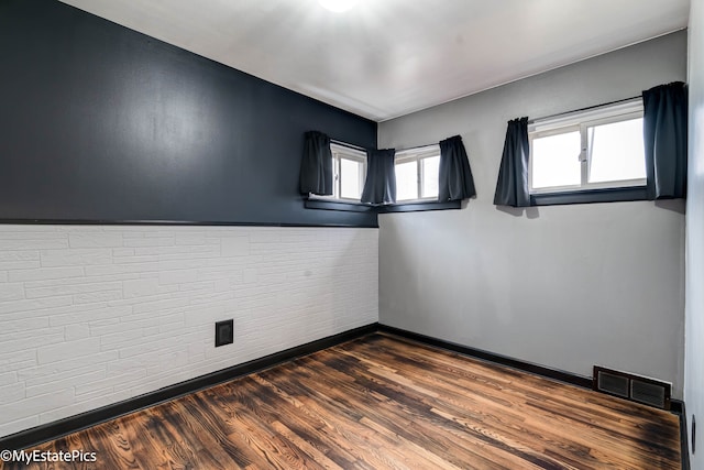 spare room featuring dark hardwood / wood-style floors