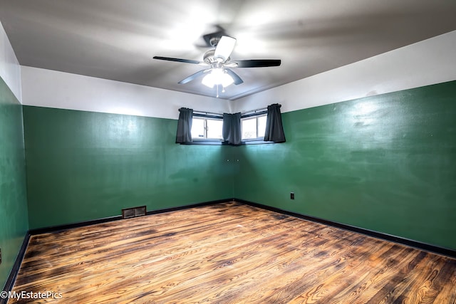 unfurnished room with hardwood / wood-style flooring and ceiling fan