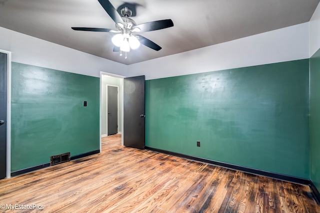 empty room featuring ceiling fan and light hardwood / wood-style floors