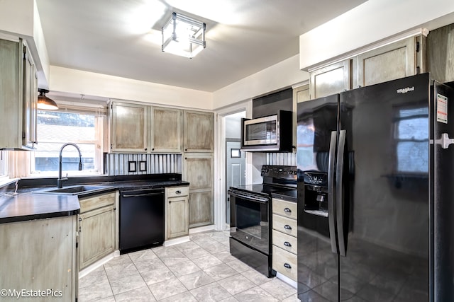 kitchen featuring light tile patterned floors, light brown cabinetry, sink, and black appliances