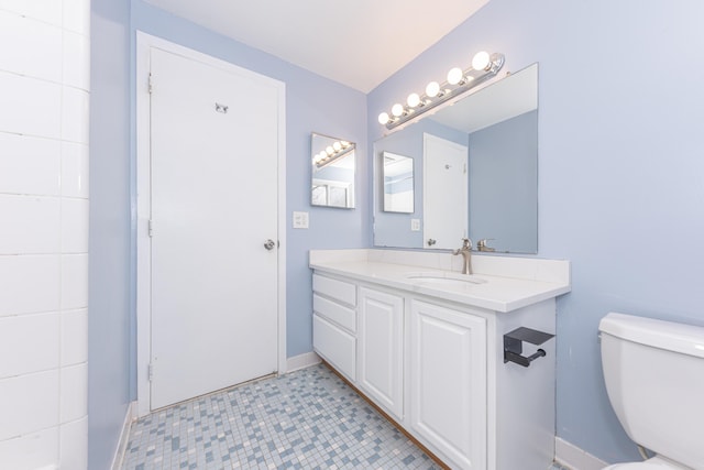 bathroom featuring vanity and toilet