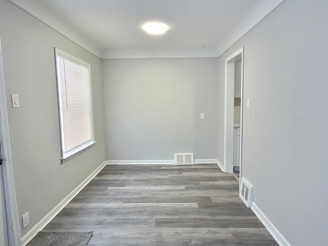 unfurnished room featuring plenty of natural light and hardwood / wood-style floors