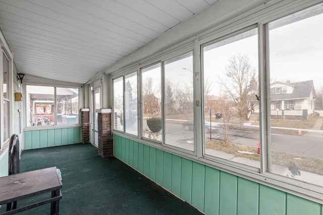 unfurnished sunroom with lofted ceiling