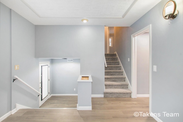 staircase featuring wood-type flooring