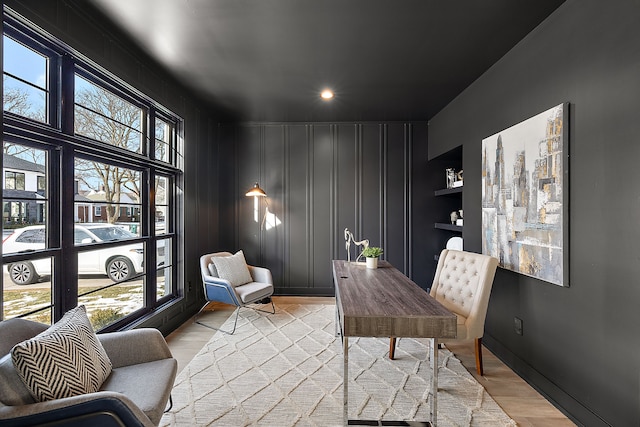 office featuring built in features and light wood-type flooring