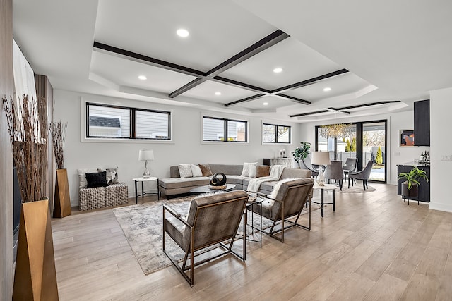 living room featuring coffered ceiling, beamed ceiling, and light wood-type flooring