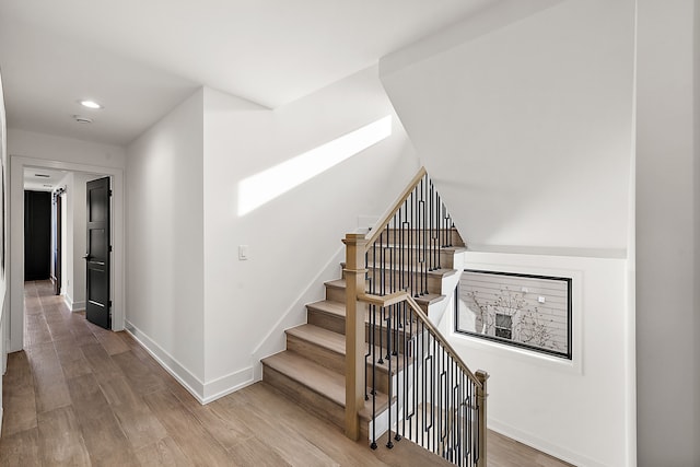 staircase featuring wood-type flooring