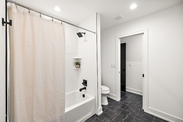 bathroom featuring shower / tub combo with curtain and toilet