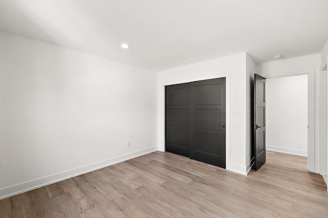 unfurnished bedroom with light wood-type flooring