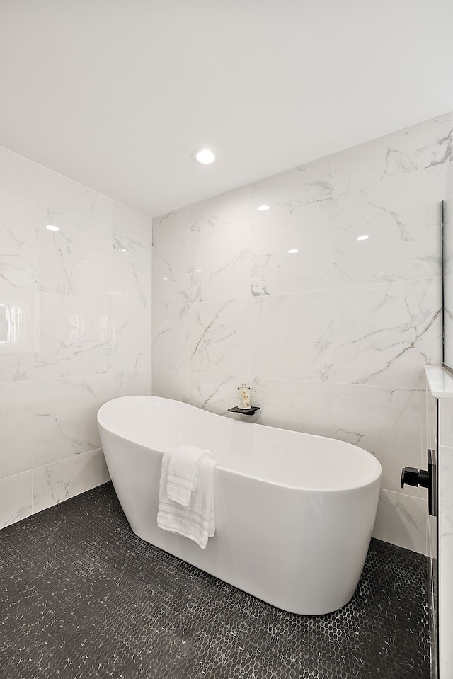 bathroom featuring a tub to relax in