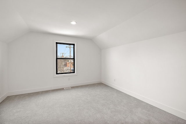 bonus room featuring lofted ceiling and carpet flooring