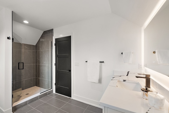 bathroom with lofted ceiling, vanity, tile patterned flooring, and a shower with shower door