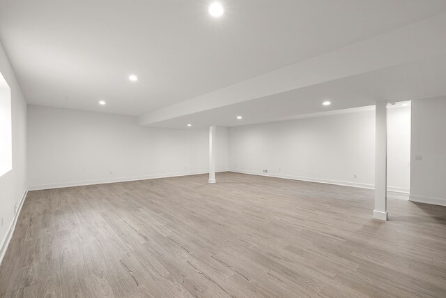 basement with light hardwood / wood-style flooring