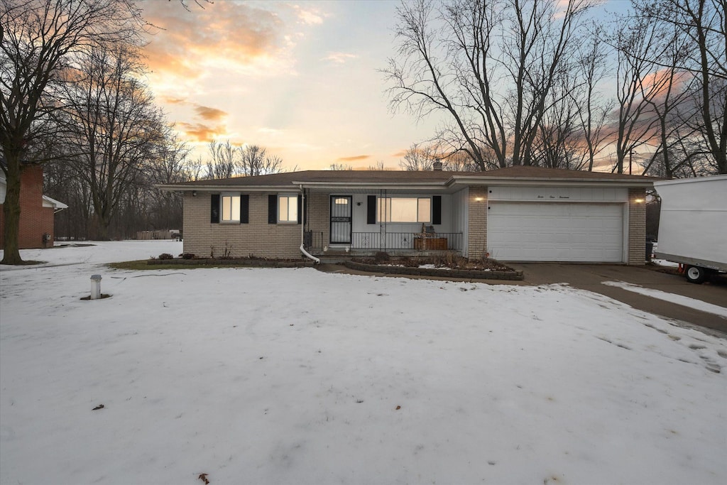 ranch-style house with a garage and covered porch