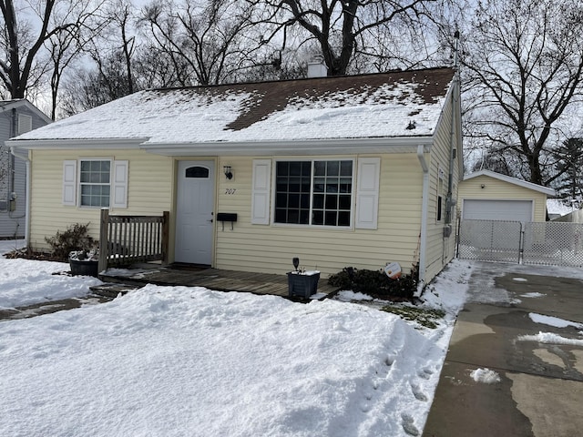 view of front of home featuring a garage and an outdoor structure